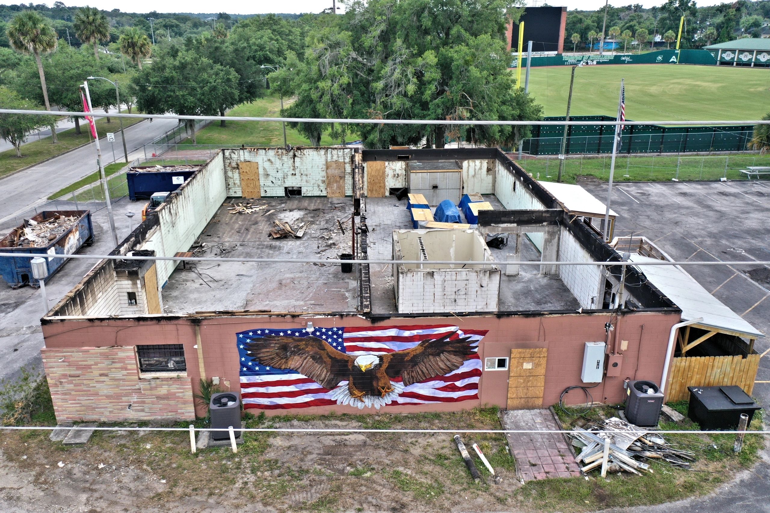 Rundown building featuring eagle and flag