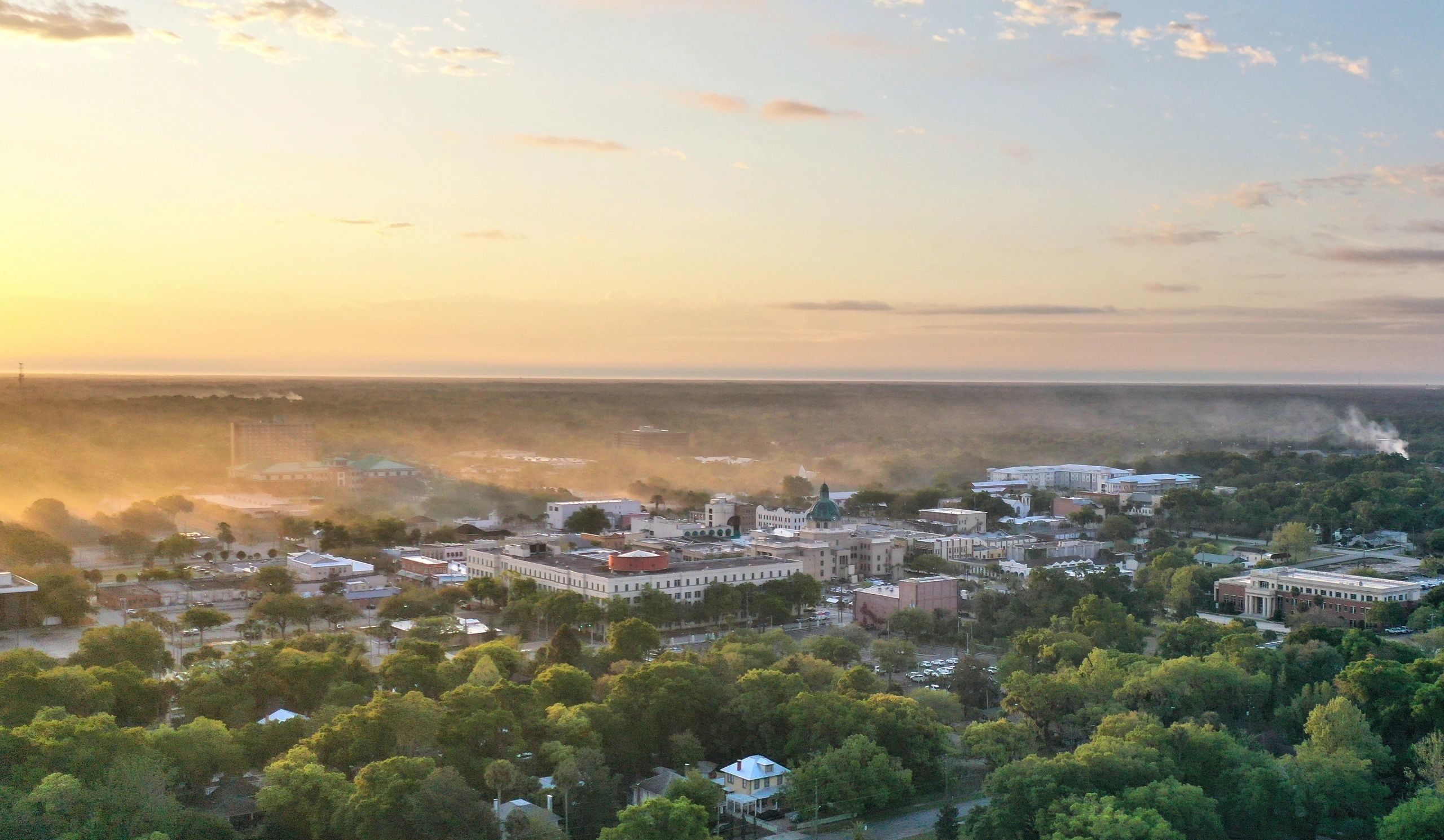 Sunrise over a misty townscape