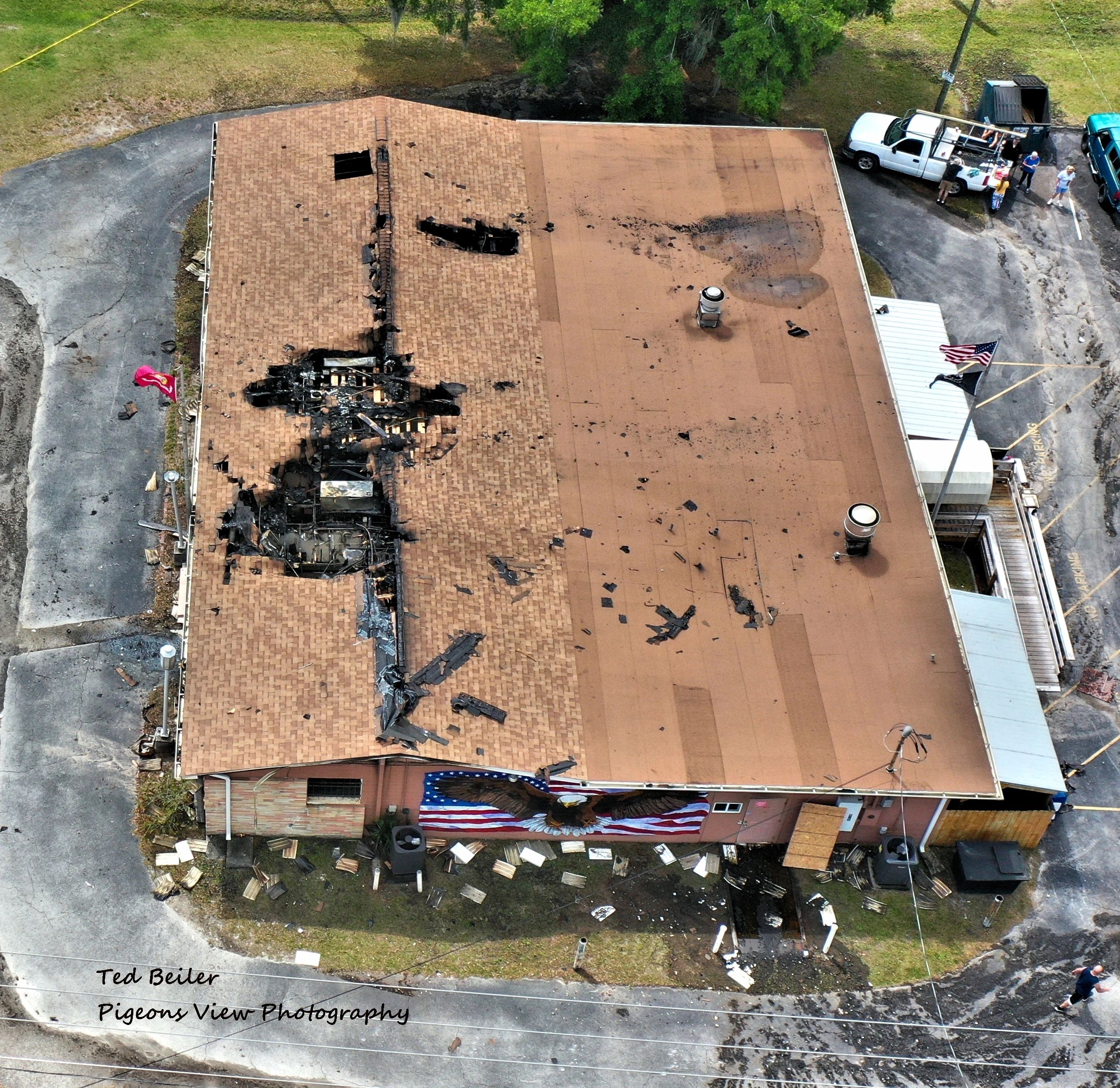 Aerial view of fire-damaged building roof.