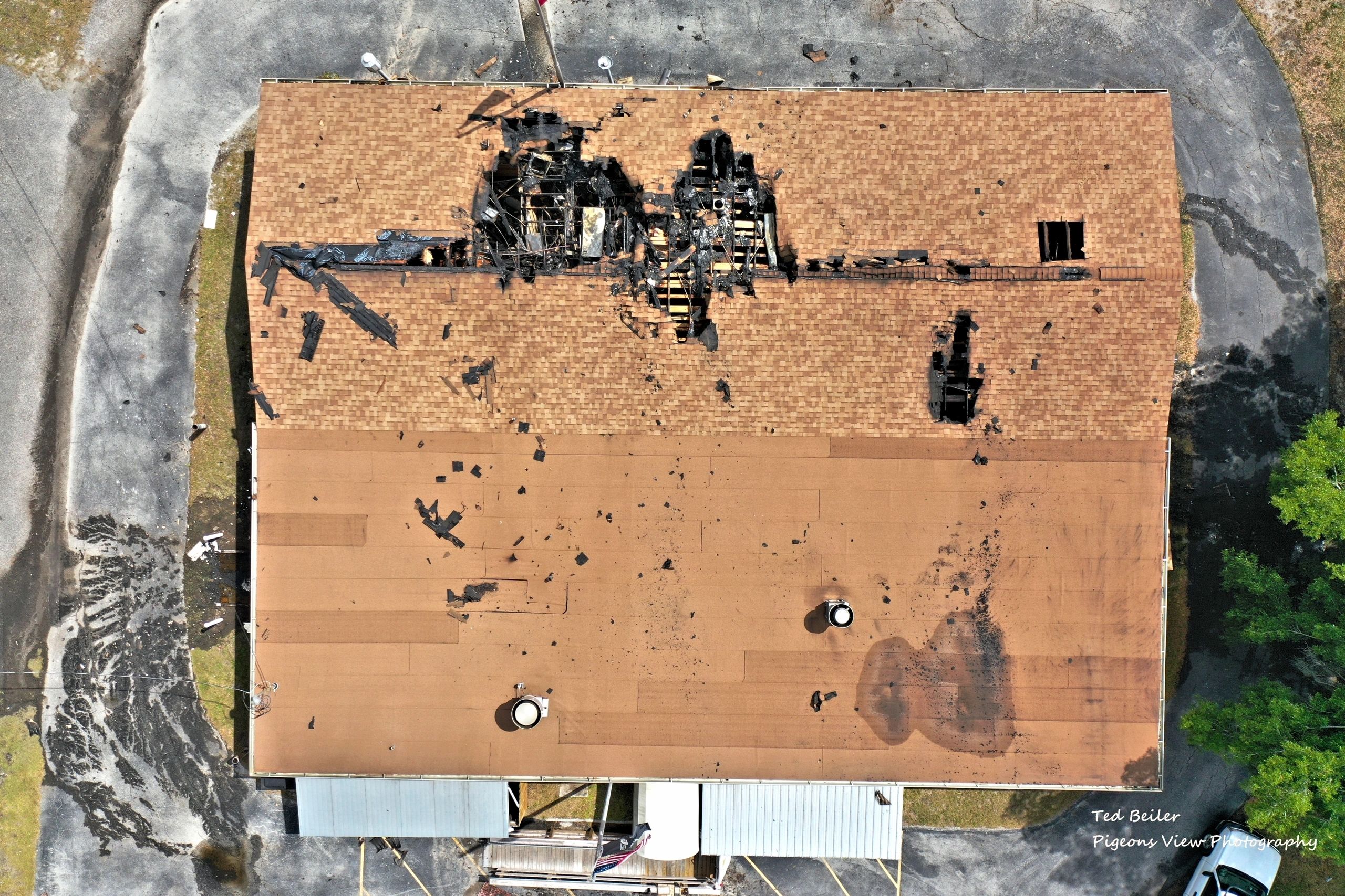 Aerial view of fire-damaged building roof