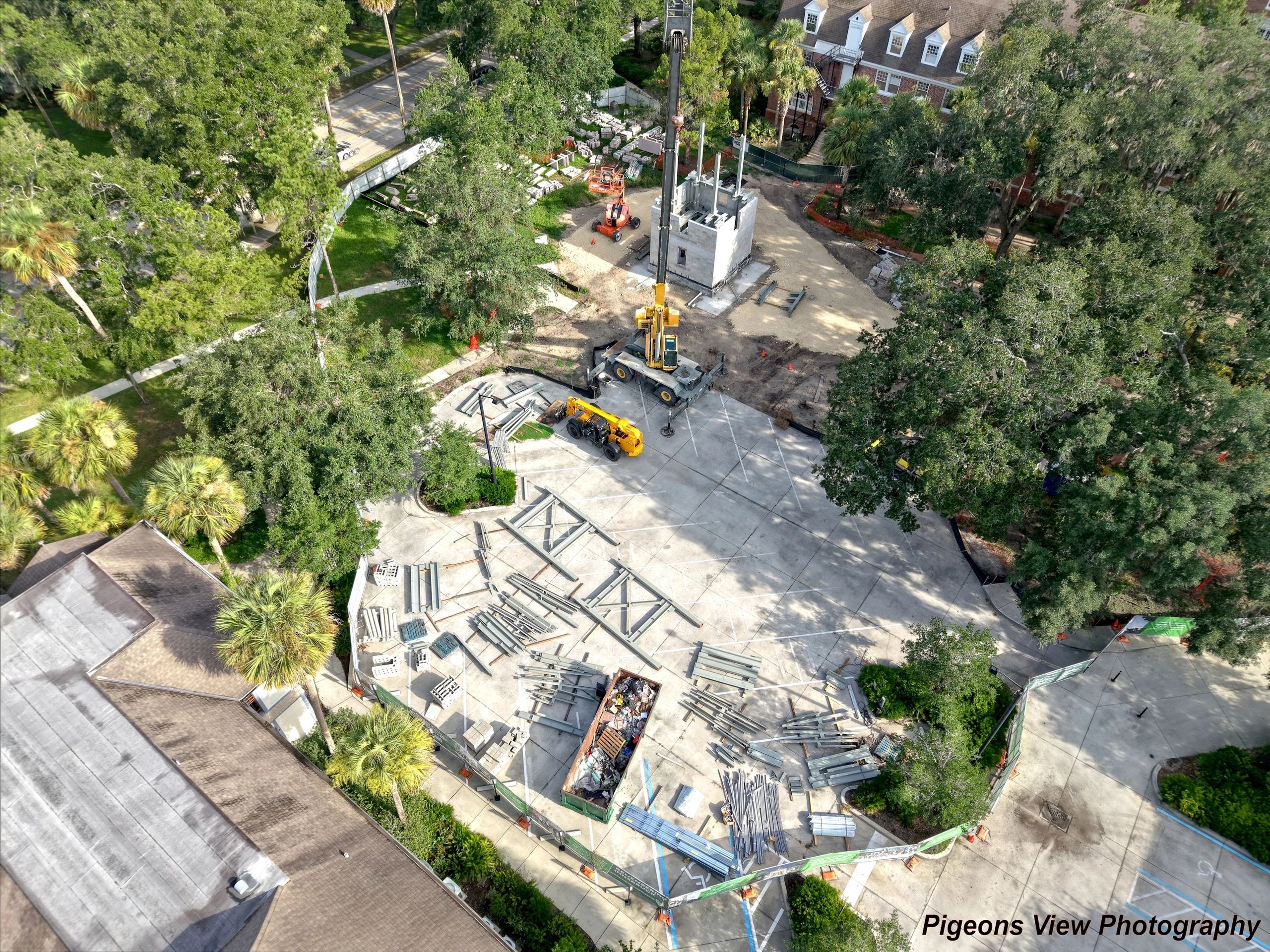 Construction site with building materials and machinery.