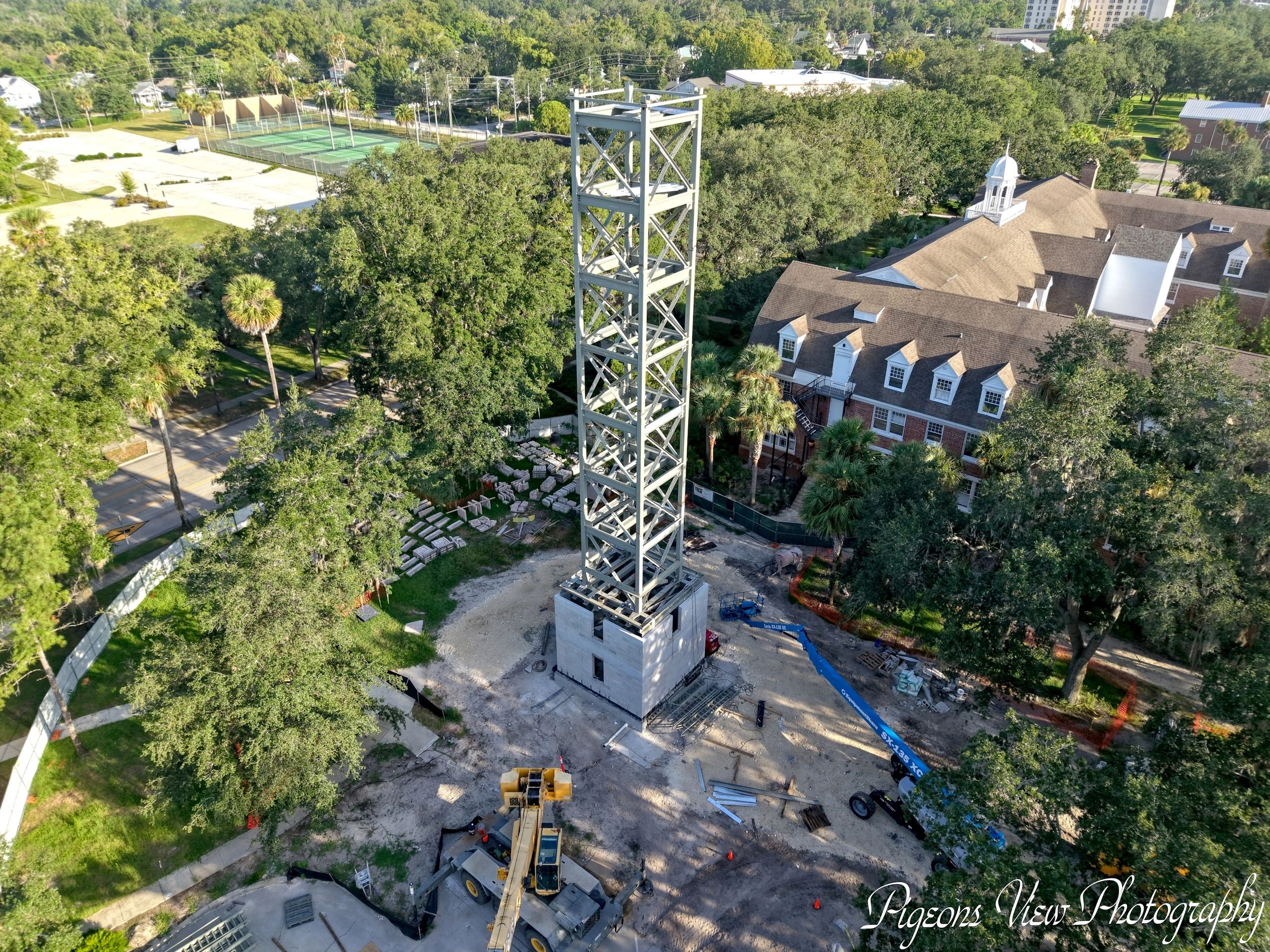 Building framework surrounded by trees and roads
