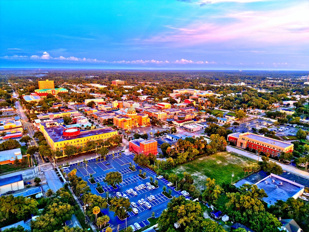 Colorful aerial view of cityscape at sunset.