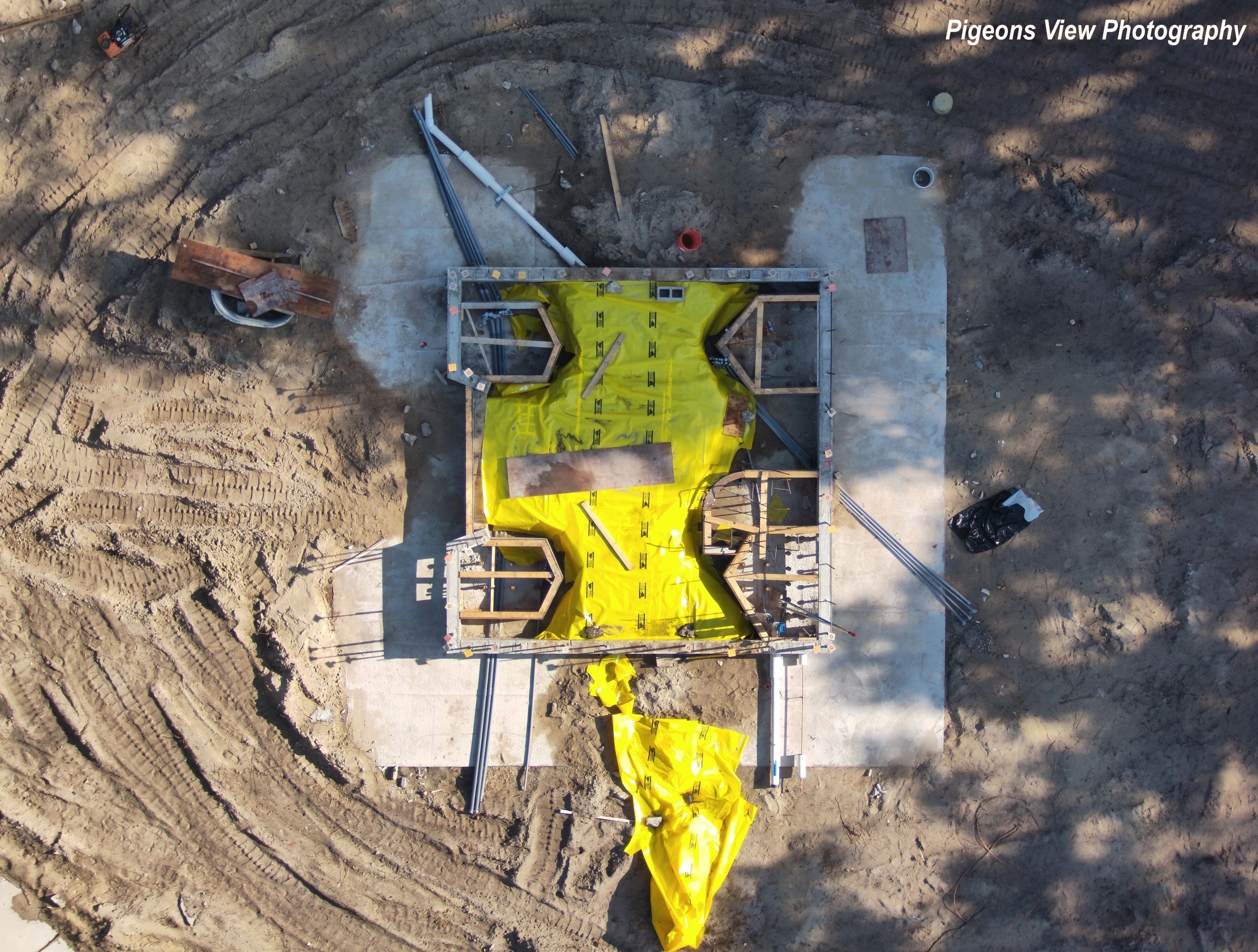 Construction site with yellow tarpaulin overhead