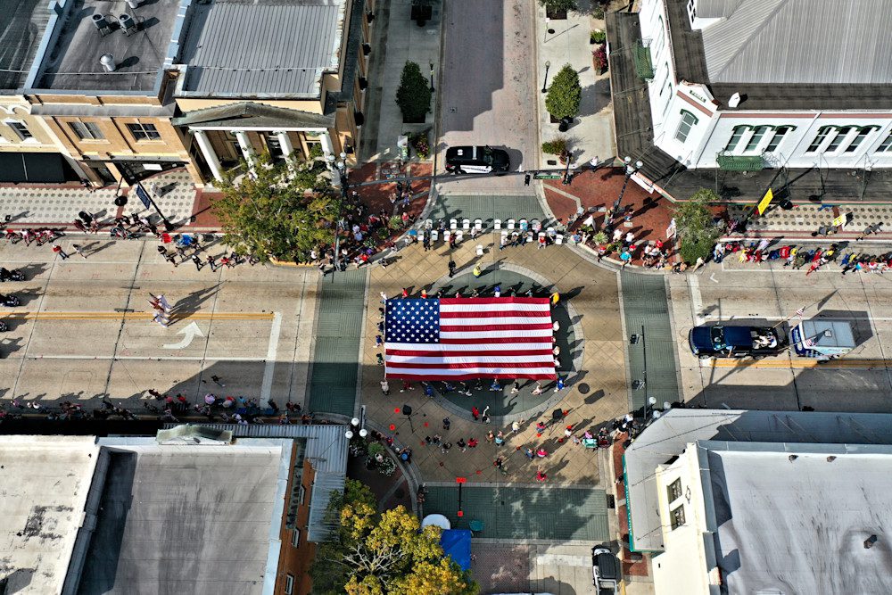 Street parade featuring American flag display