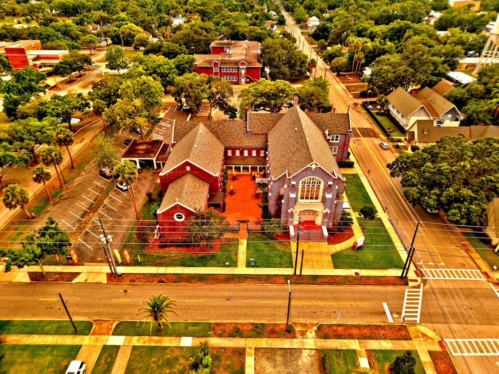 Red church with intricate architecture and gardens