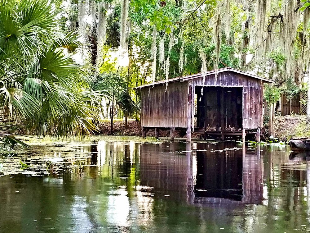 Serene water reflection of an old cabin