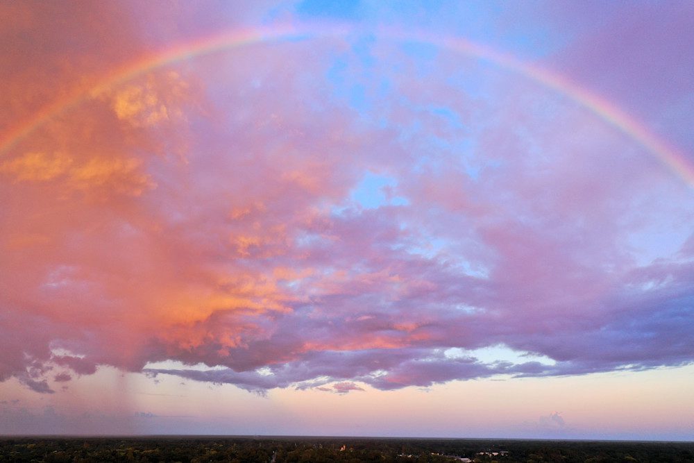 Vibrant rainbow over evening clouds