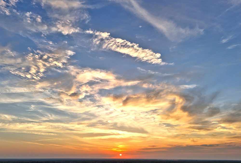 Golden sunset sky with clouds
