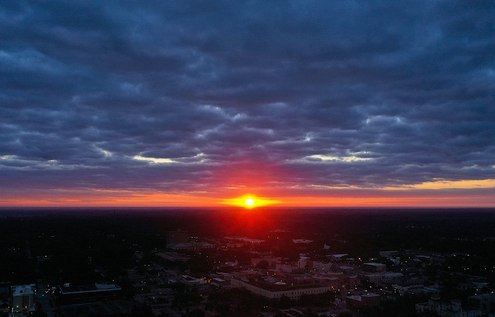 Sunset over a cityscape with clouds