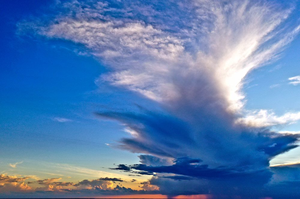 Dramatic clouds over a colorful sunset sky.