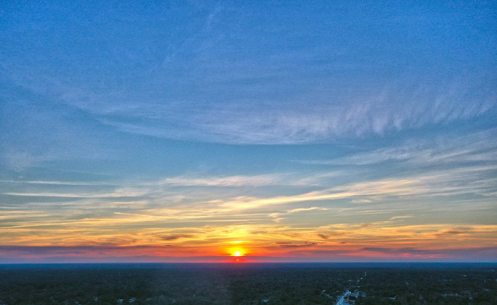Vibrant sunset with expansive blue sky