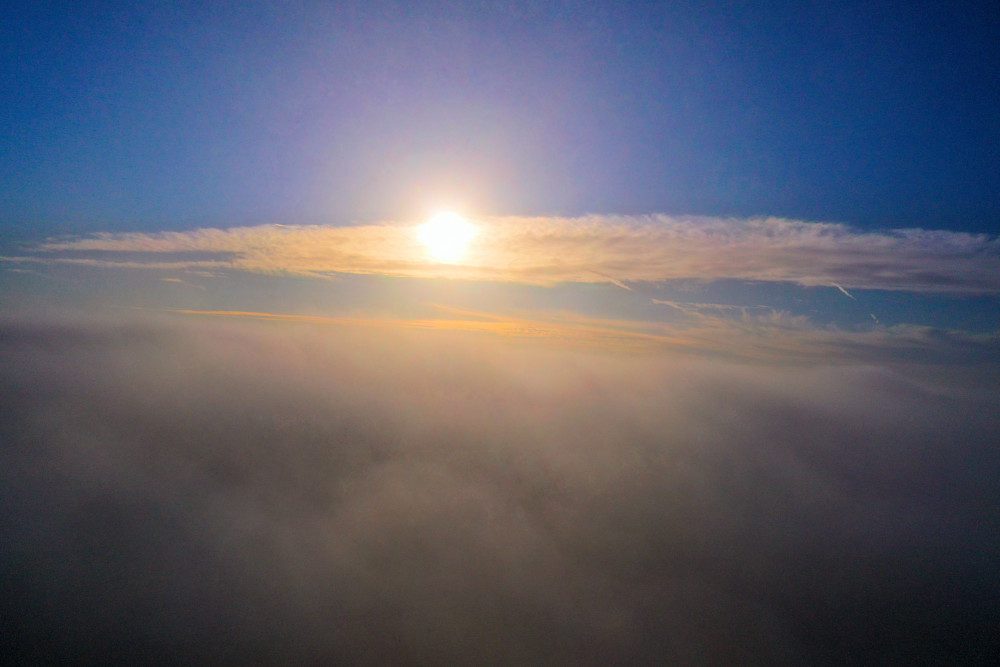 Sunrise over misty clouds