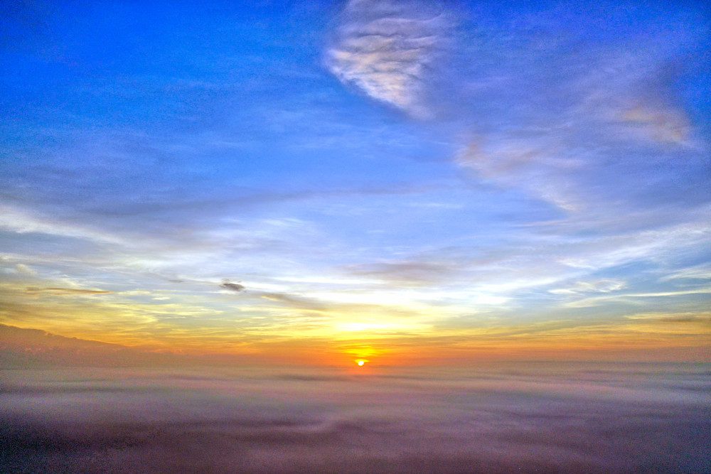 Golden sun rising over horizon