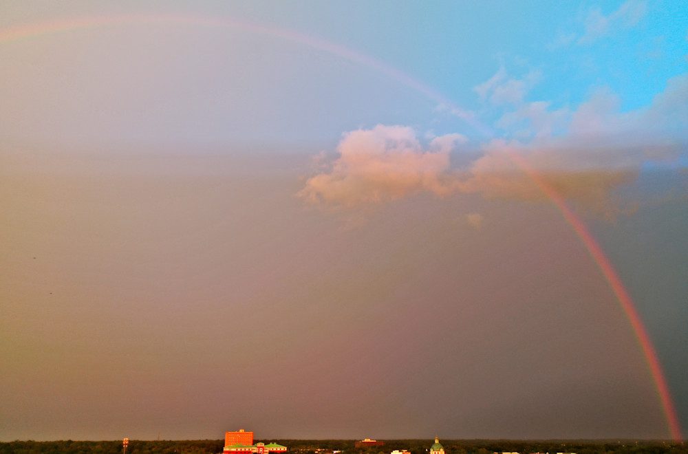 Rainbow arching across a cloudy sky