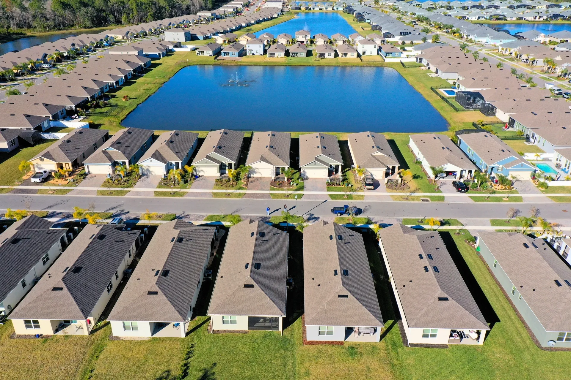 Aerial view of suburban neighborhood and pond.