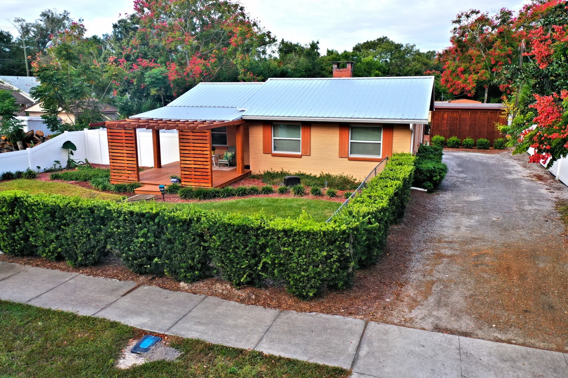 Single-story house with green hedge