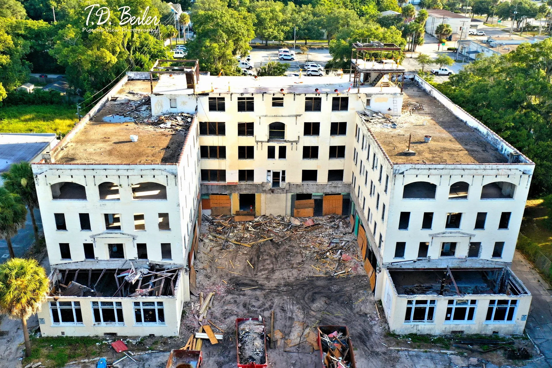 Partially demolished building surrounded by trees