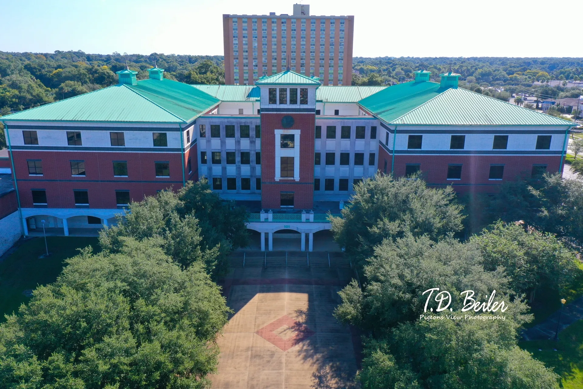 Red-brick building with green roofs