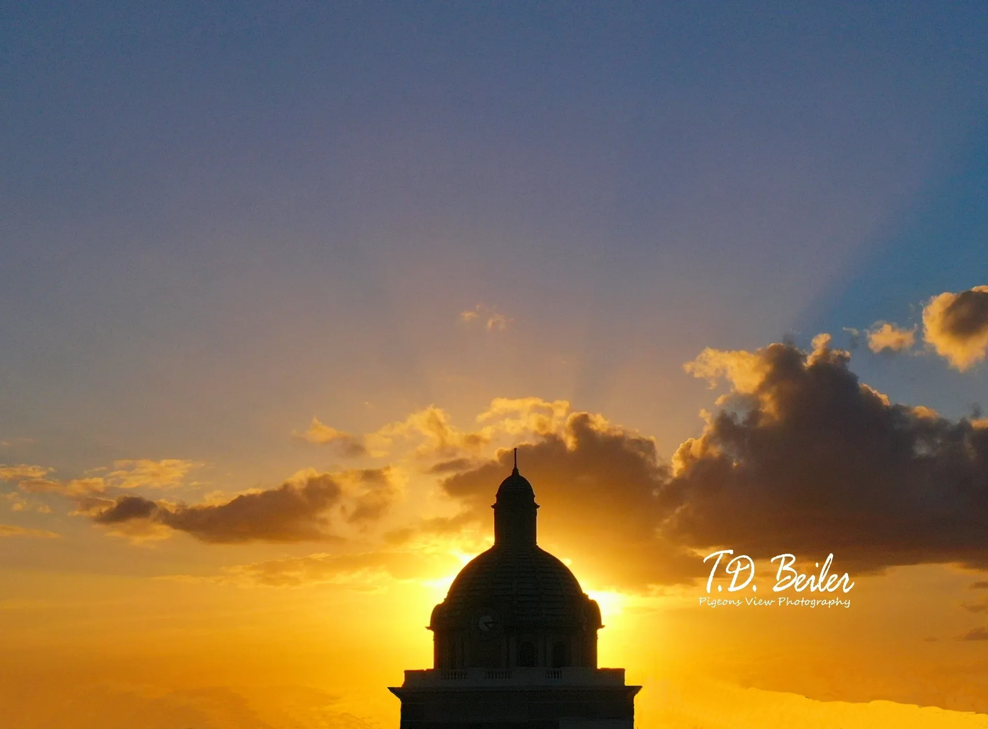 Golden sunset with silhouetted dome
