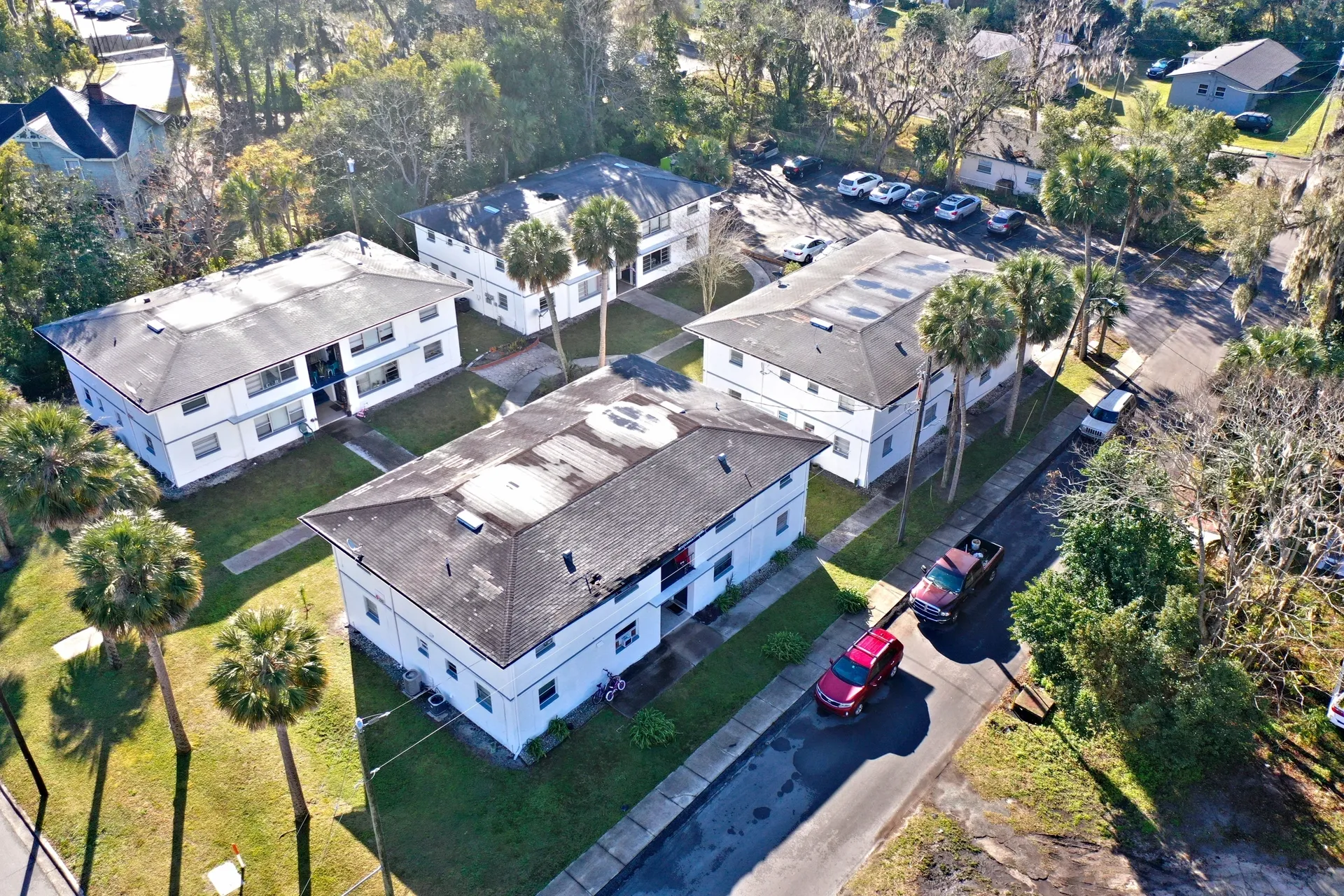 Palm trees surrounding white apartment buildings
