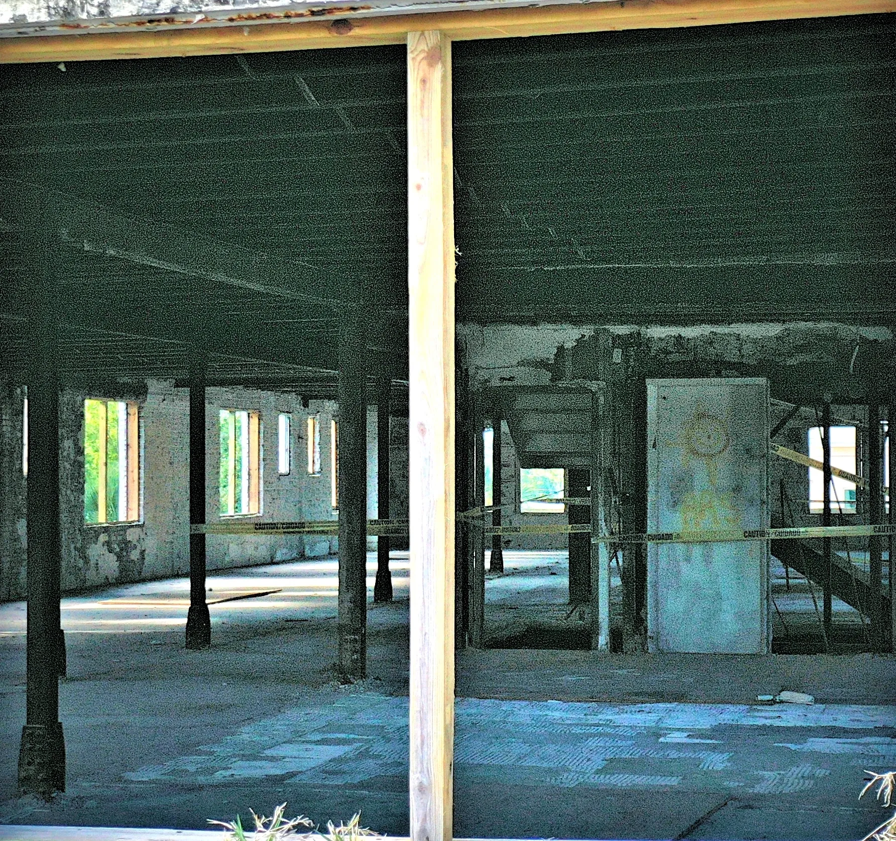 Empty warehouse with peeling paint and pillars