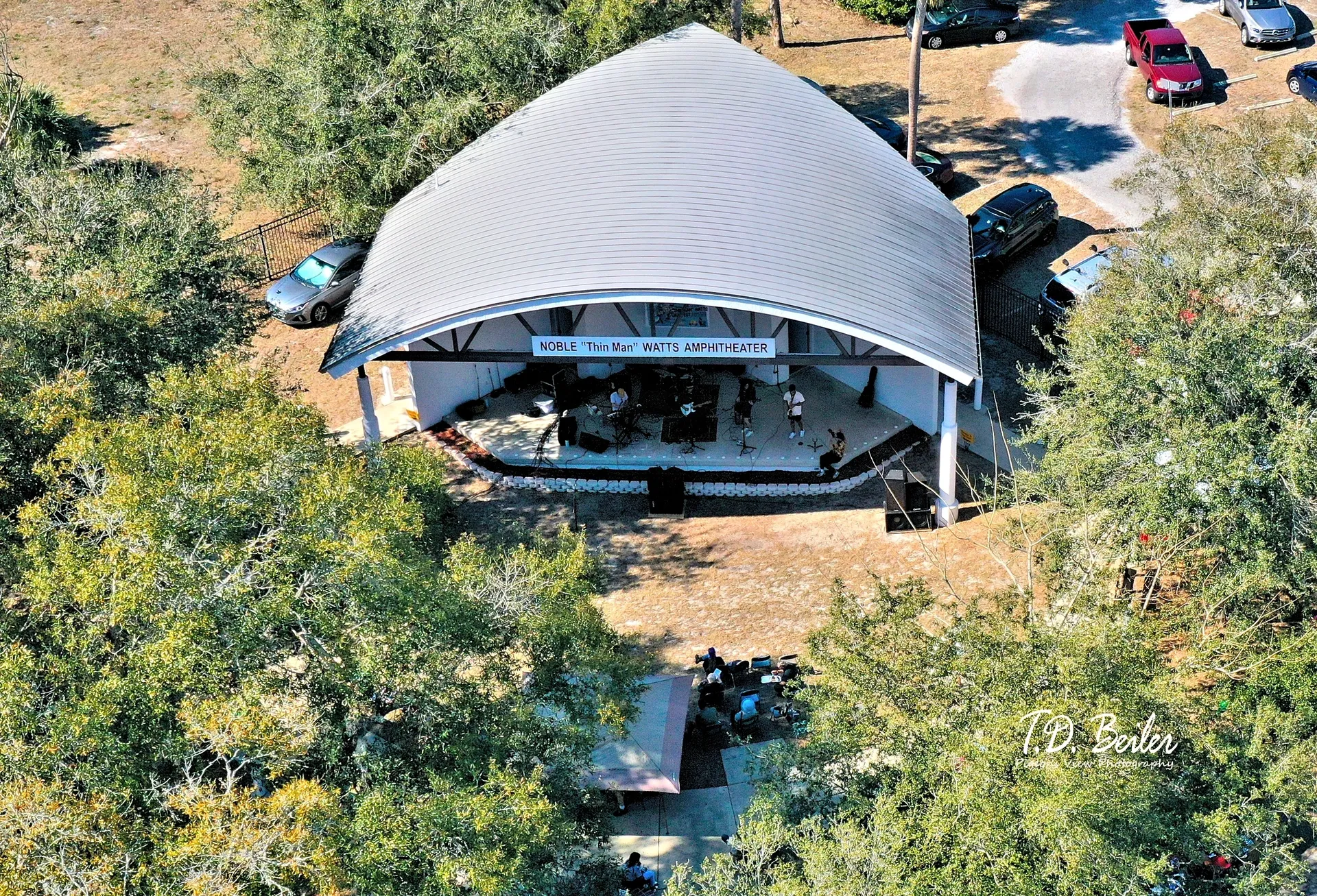 Covered amphitheater with parked cars nearby