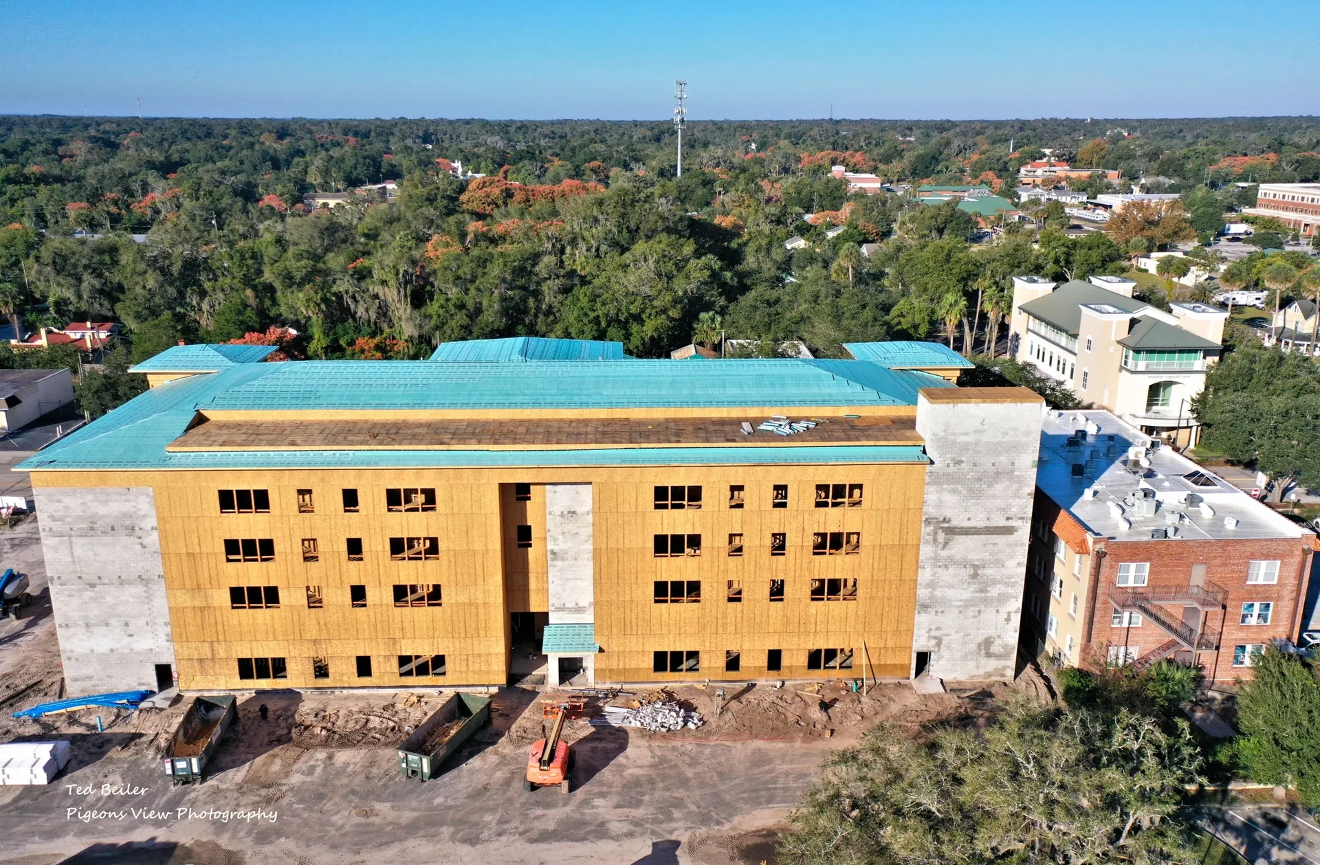 Building under construction with trees nearby