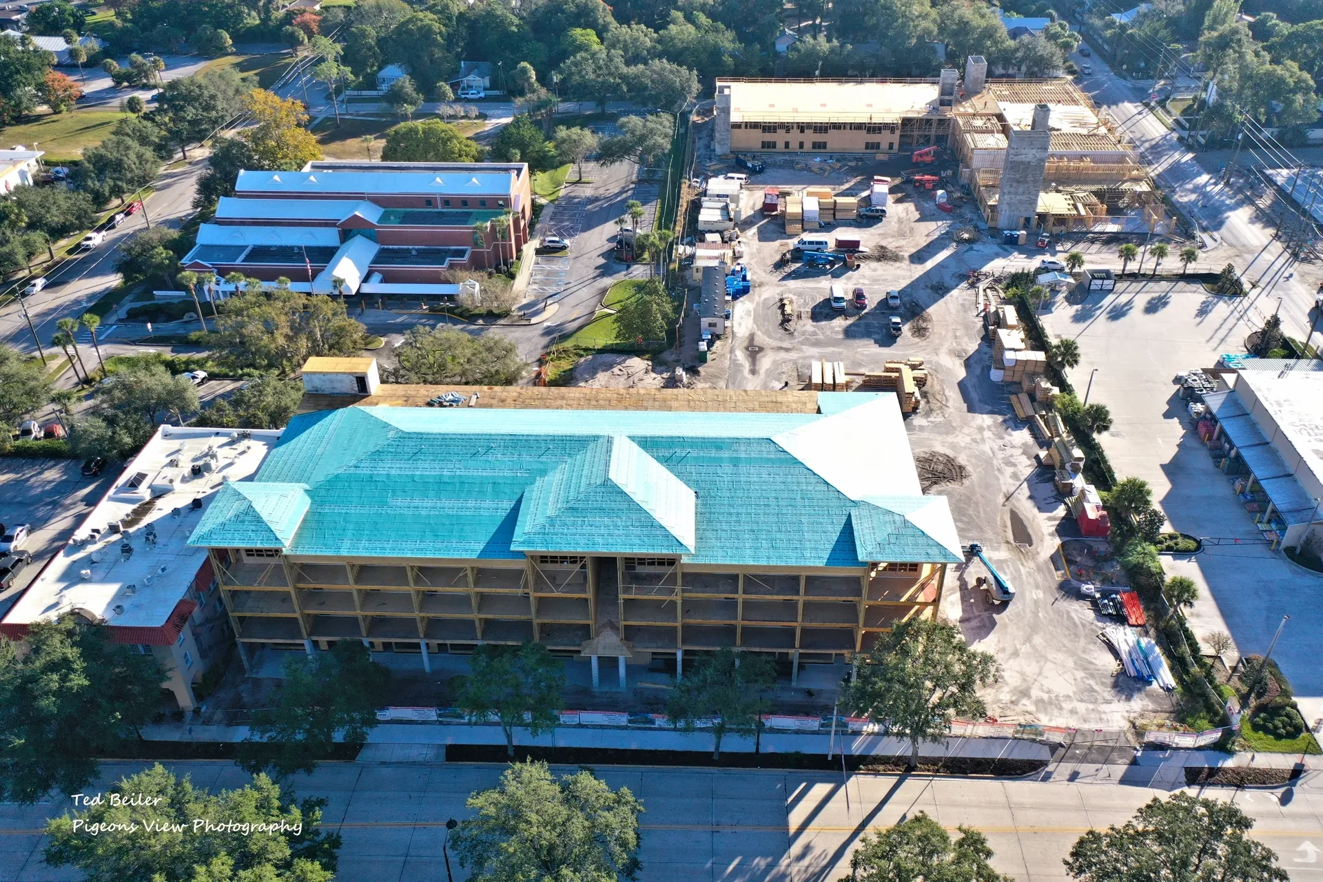 Building under construction with teal roof