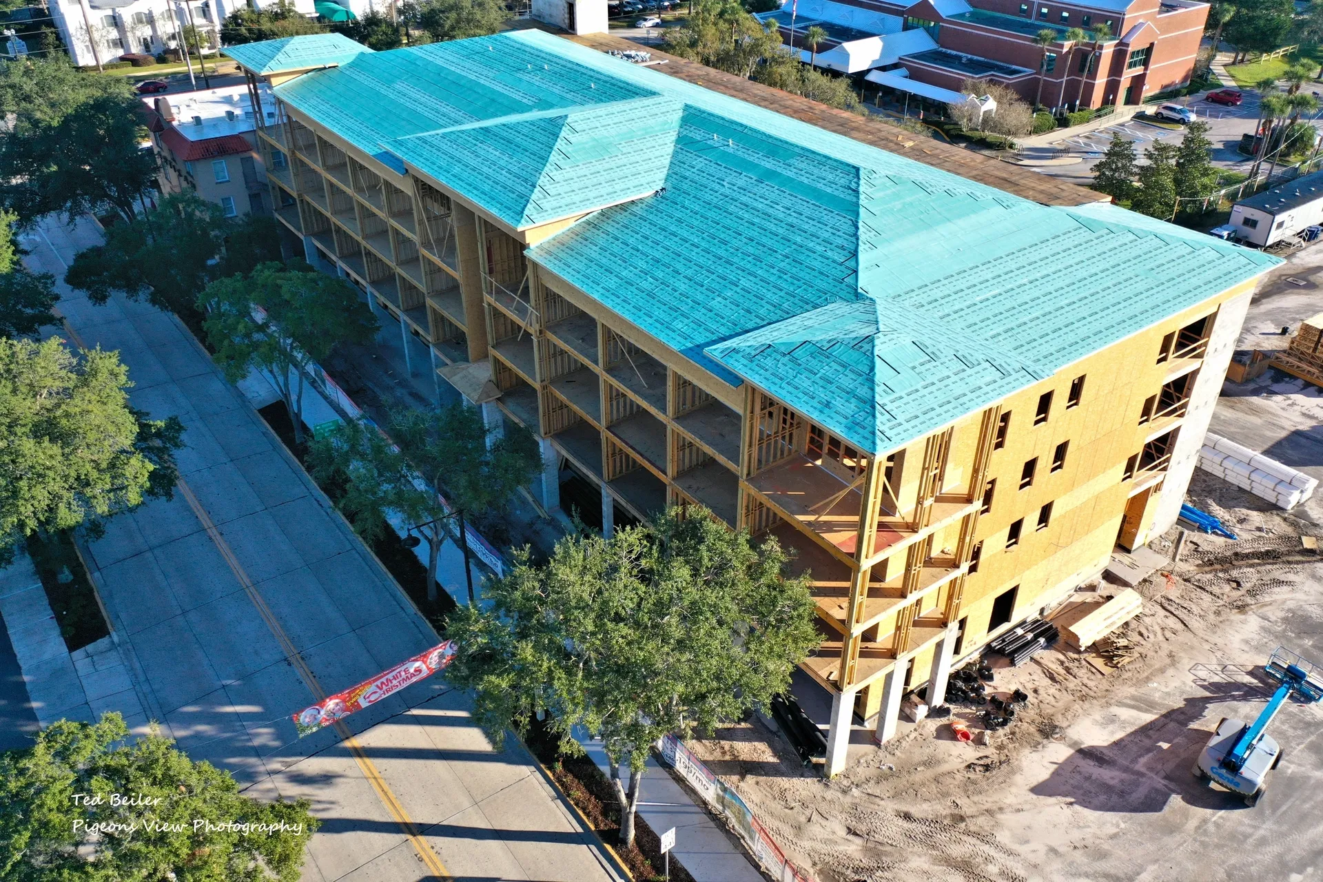 Building under construction with teal roof