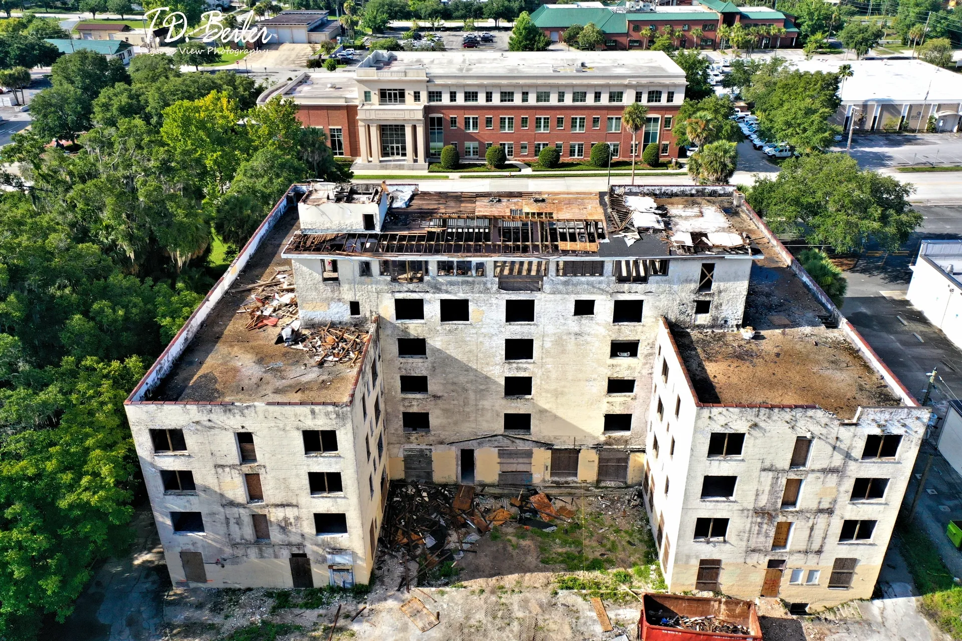 Old, dilapidated building surrounded by trees
