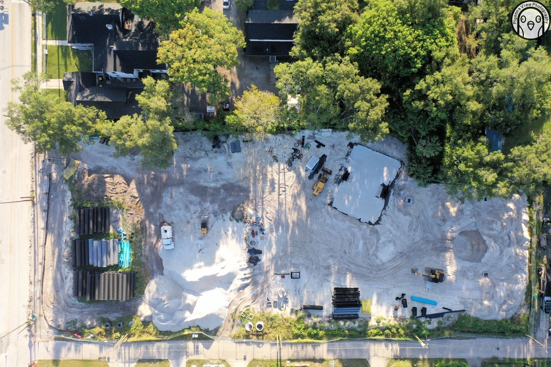 Construction site with equipment and trees