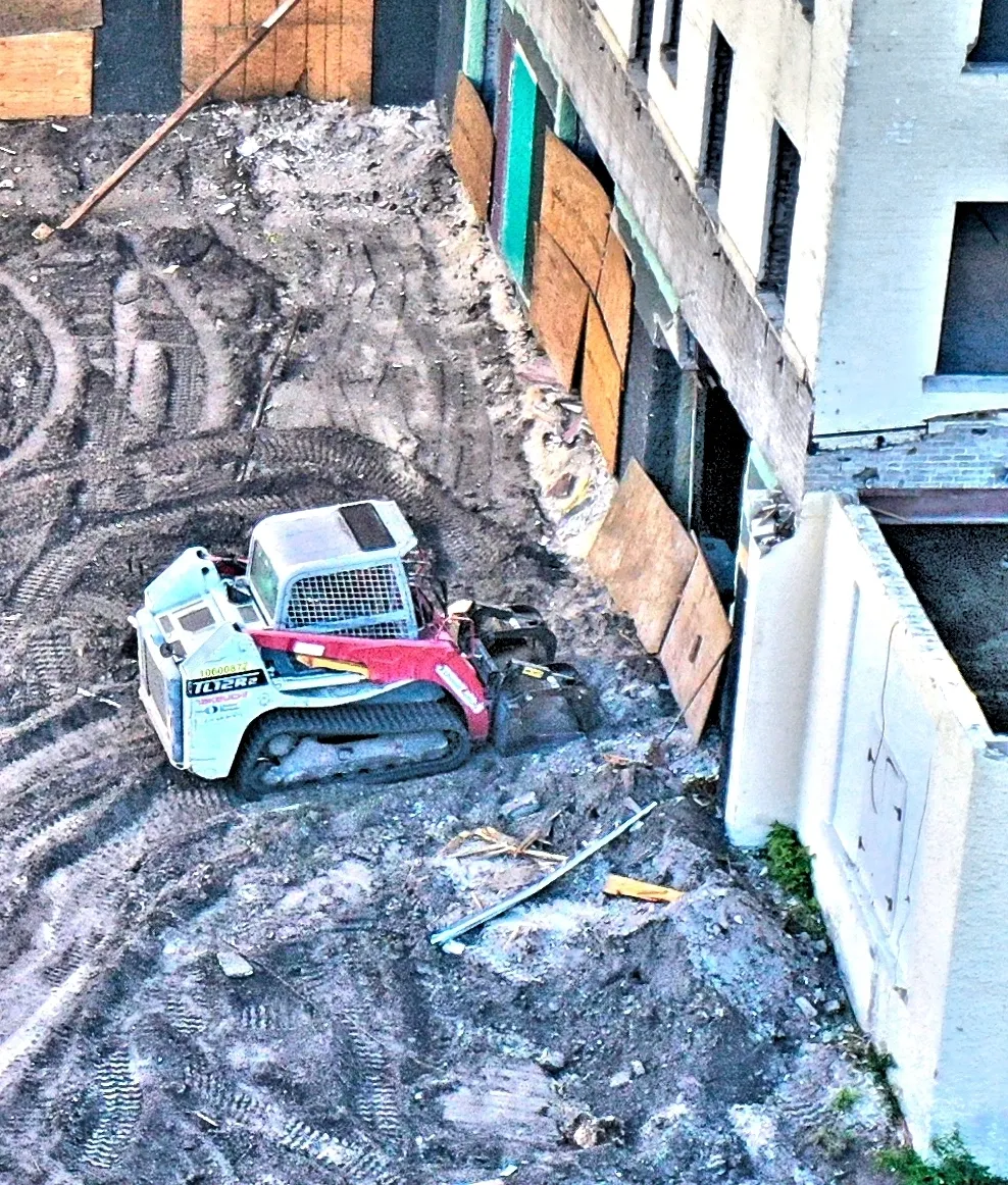 Excavator at urban building site