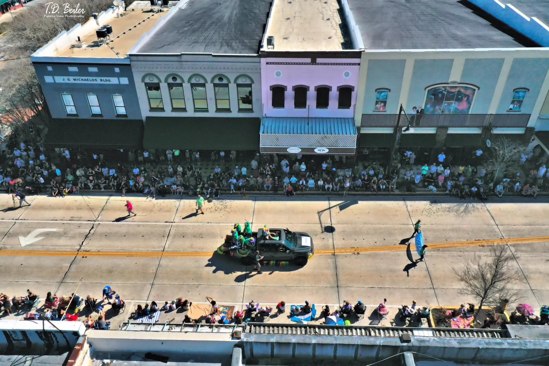 Parade with truck on city street