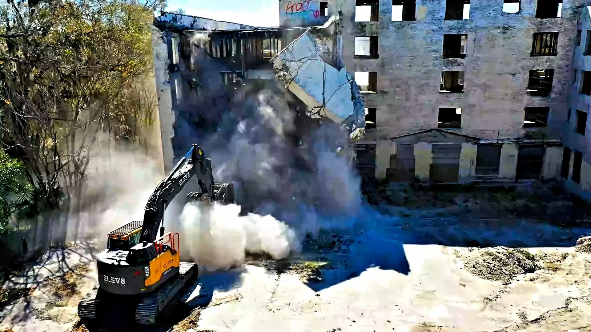 Building demolition with excavator