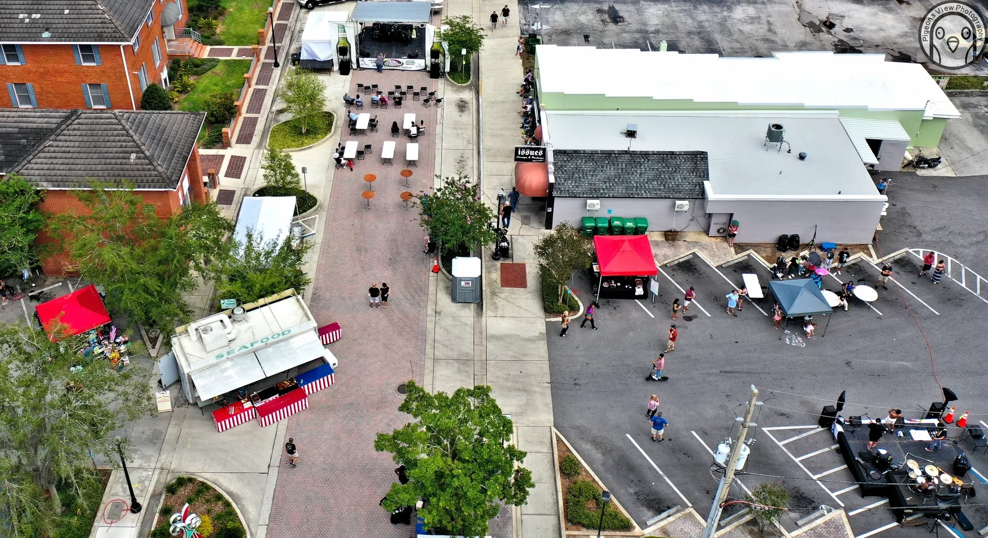 Open-air gathering with tents and tables
