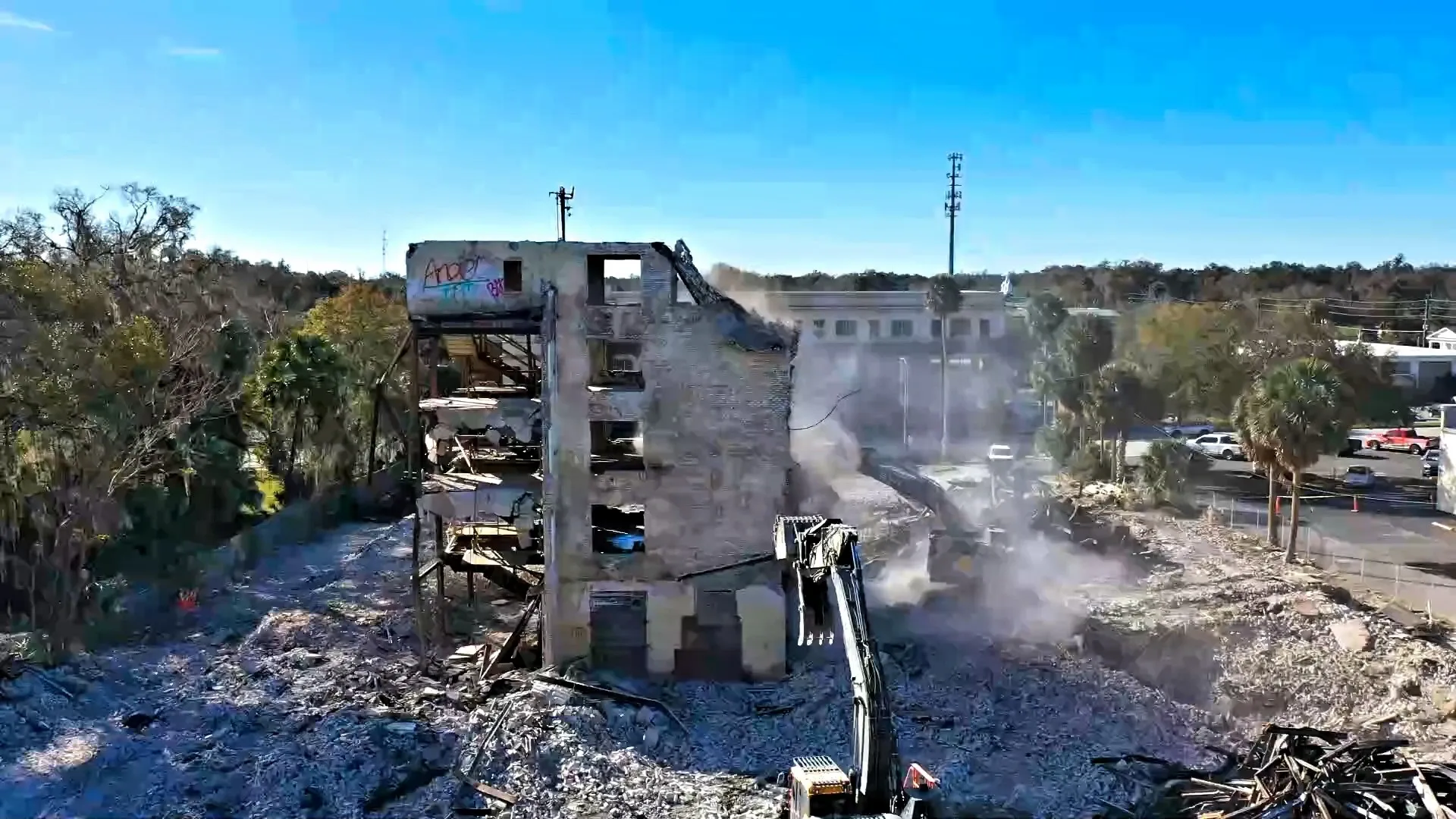 Building demolition in progress with excavator