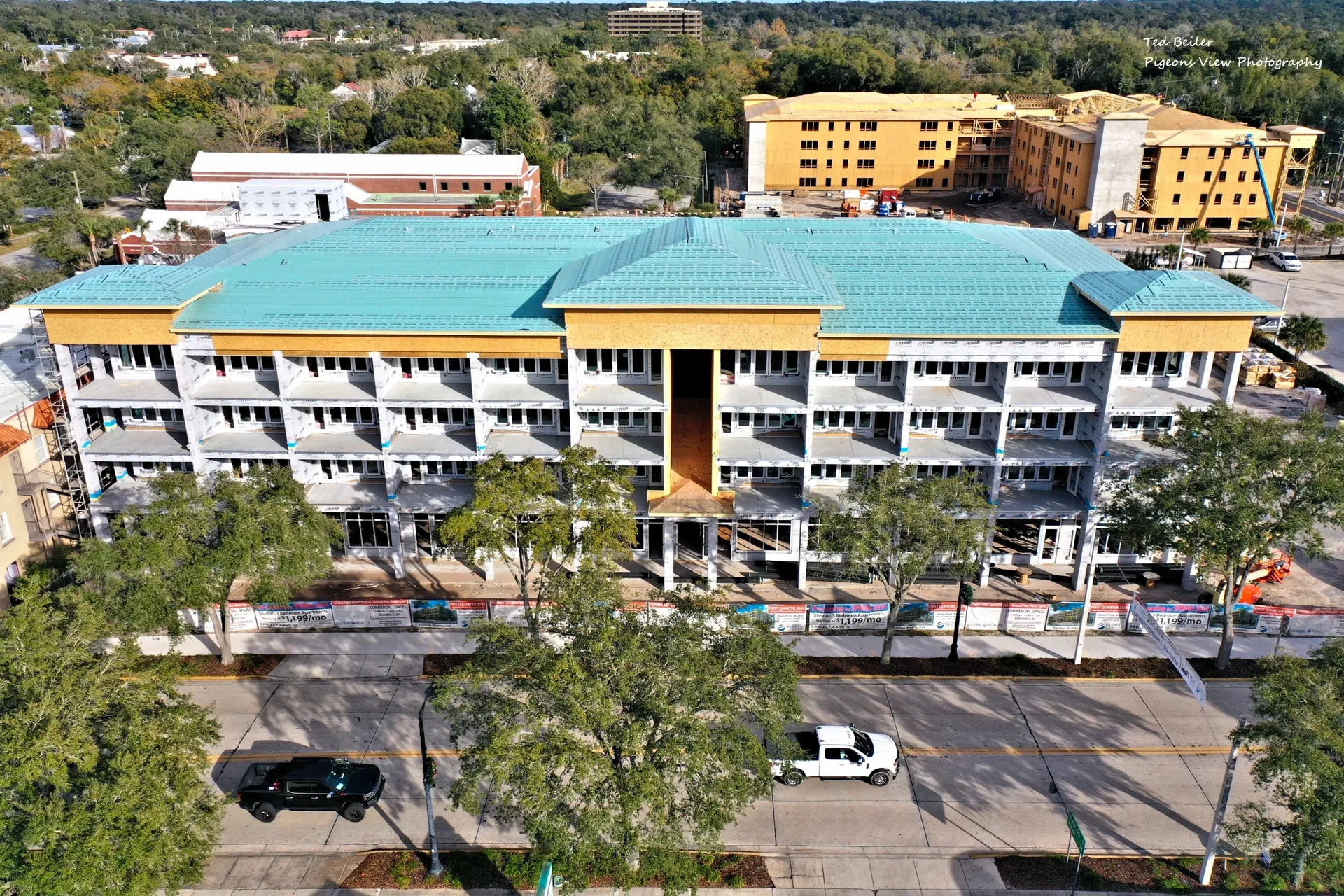 Construction site with teal and yellow building