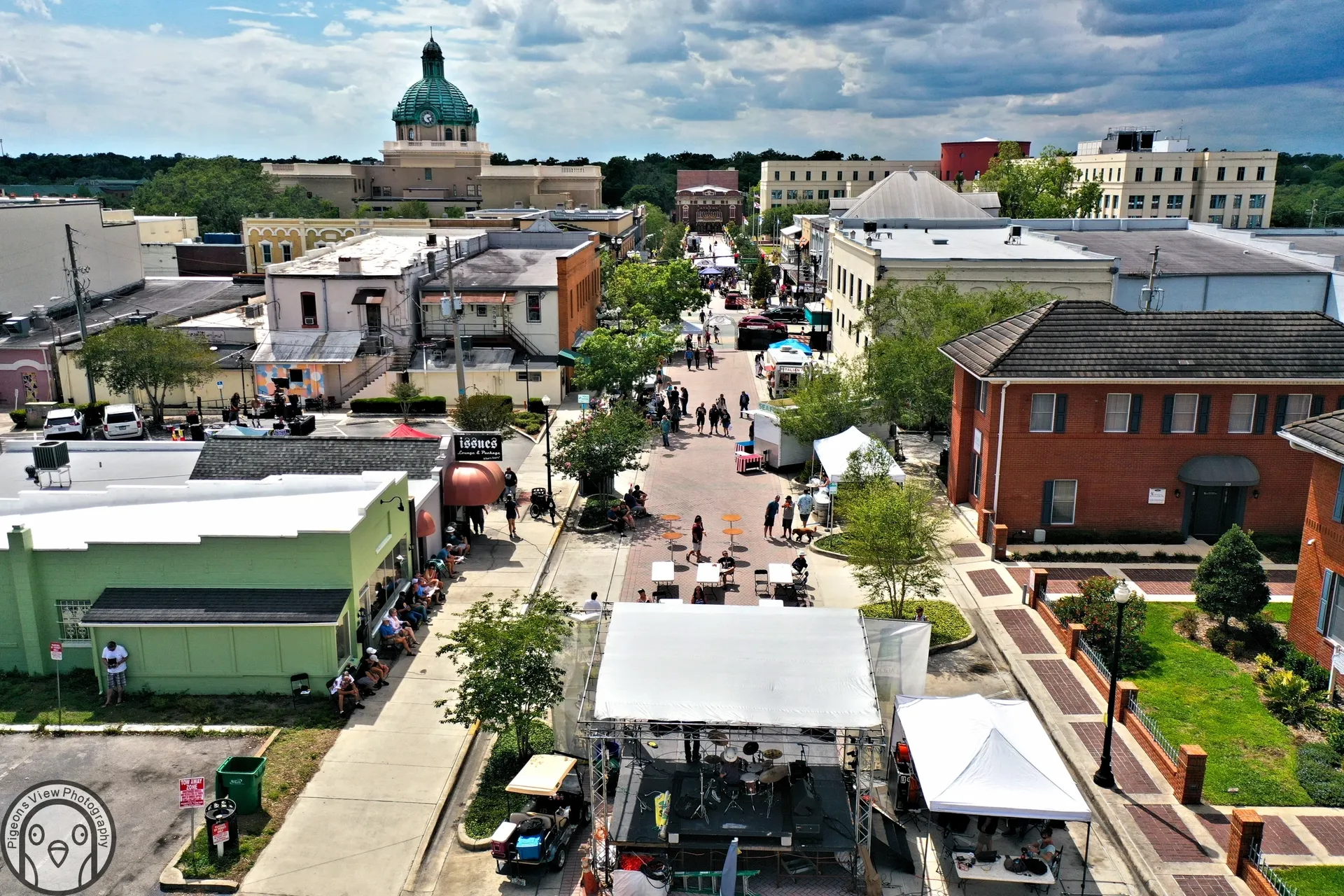 City street market with people and stalls.