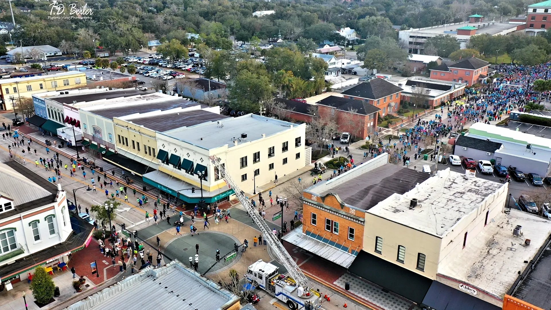 Crowds gathering in a vibrant town square.