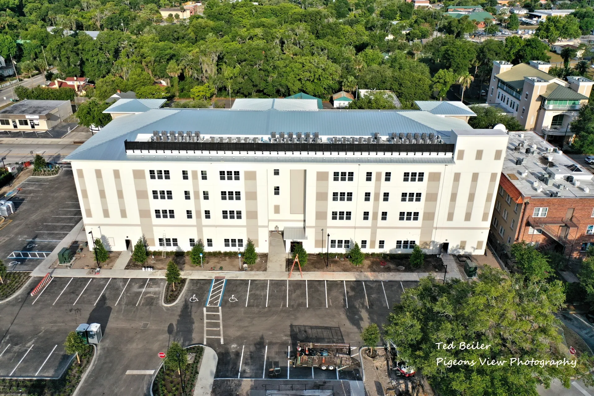 Aerial view of large building and parking lot