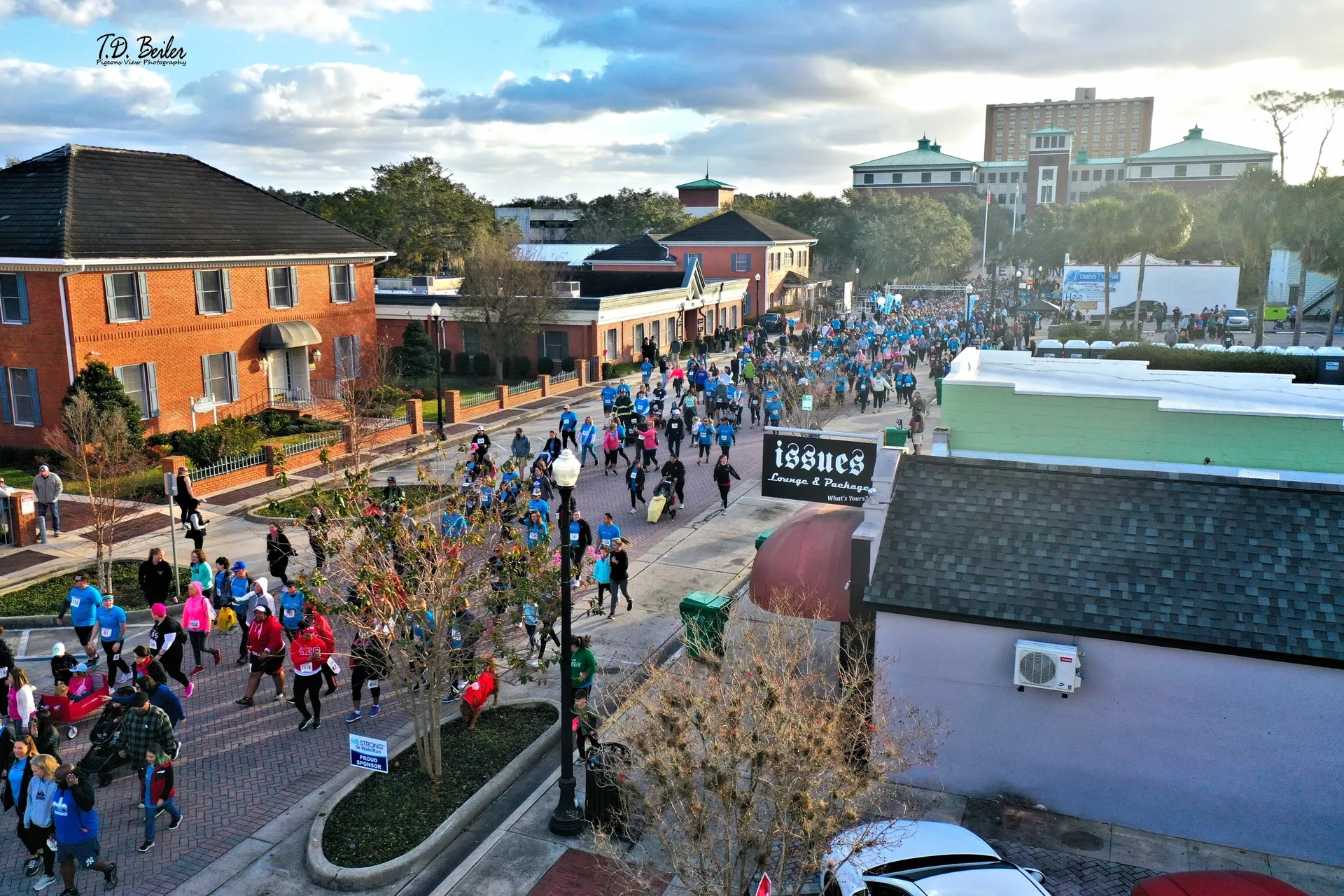 Crowd running through urban neighborhood