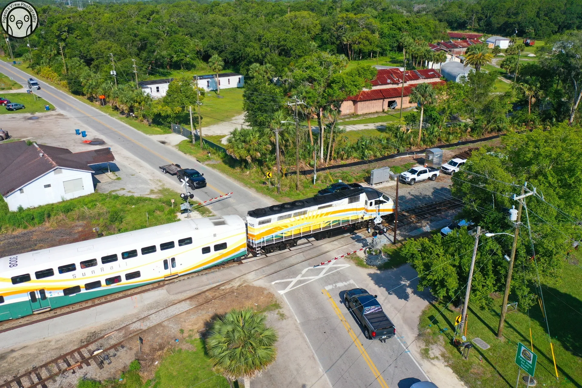 Train crossing rural road intersection