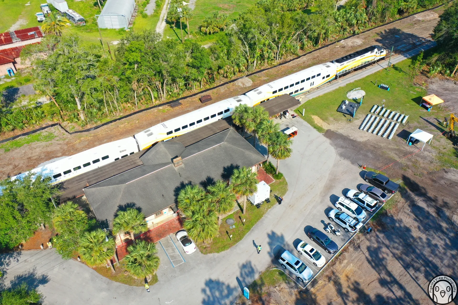 White train beside parking lot and trees