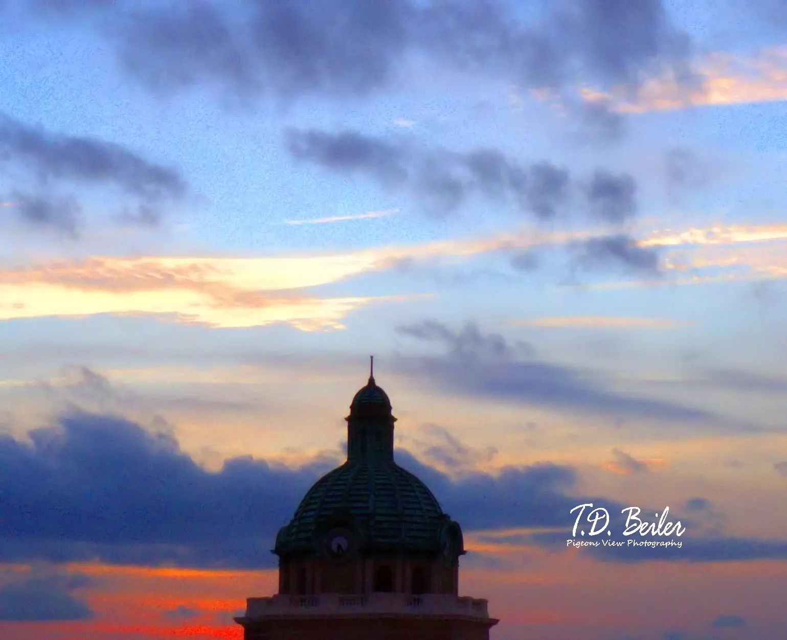 Sunset hues behind architectural dome